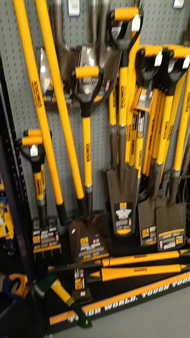 Roughneck spades, forks and shovels racked in the shop